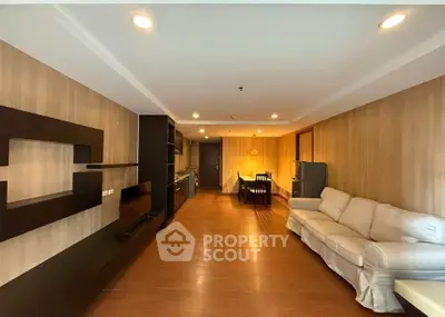 Spacious living room with modern decor and open kitchen layout, perfect for entertaining.