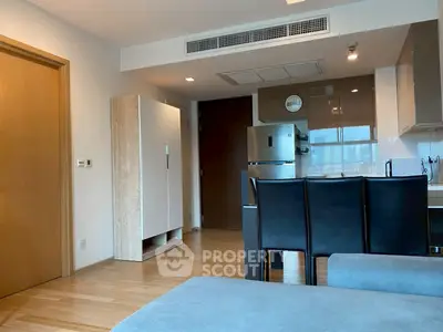 Modern open-plan living room with sleek kitchen and stylish furniture