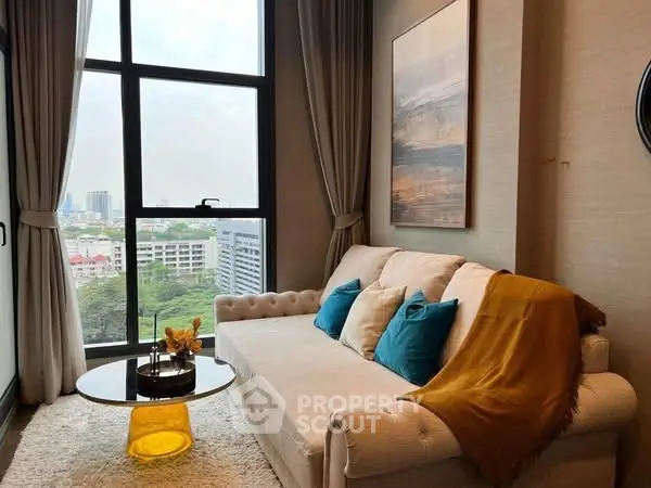 Cozy living room with large window and stylish decor in modern apartment.