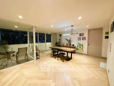 Spacious modern living room with wooden flooring and balcony view