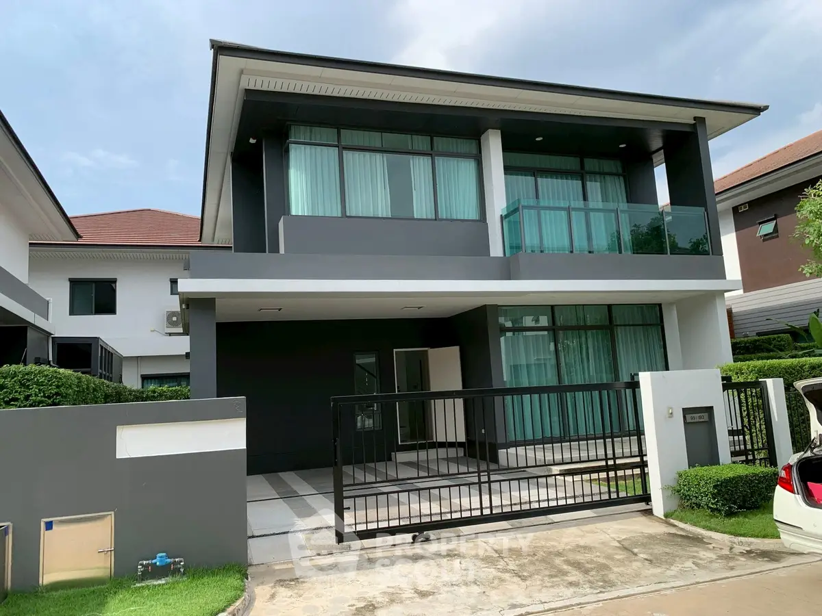 Modern two-story house with sleek design and spacious driveway