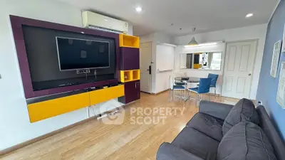 Modern living room with stylish TV unit and cozy seating area in a contemporary apartment.