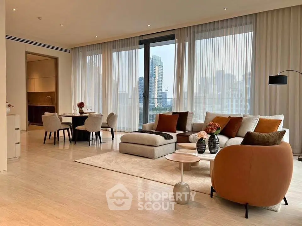 Luxurious modern living room with city view, elegant furniture, and open dining area.