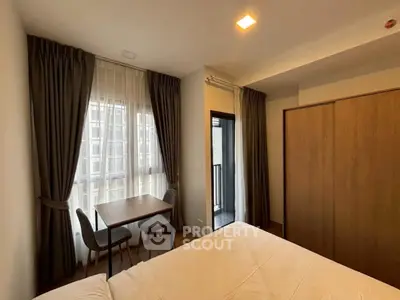 Cozy bedroom with balcony access and elegant curtains in modern apartment