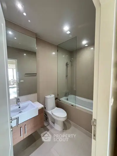 Modern bathroom with sleek fixtures and bathtub in a stylish apartment.