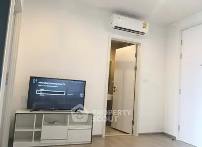 Modern living room with Samsung Smart TV and air conditioning unit, featuring sleek white decor.