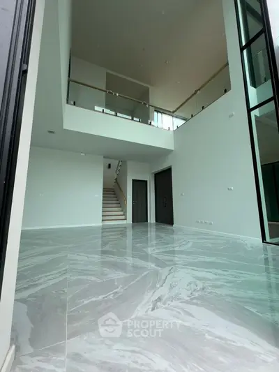 Spacious modern living room with high ceilings and elegant marble flooring