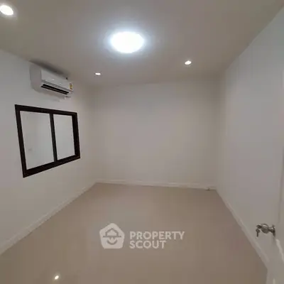 Minimalist empty room with air conditioning and recessed lighting