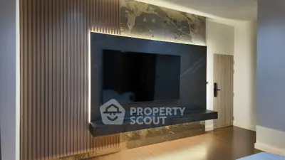 Modern living room with sleek TV wall design and ambient lighting