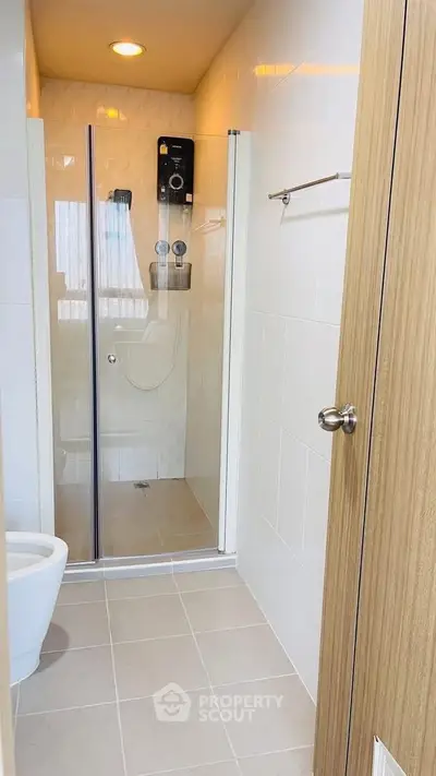 Modern bathroom with glass shower enclosure and sleek fixtures
