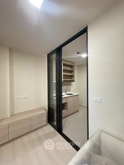 Modern kitchen with sliding glass door and sleek cabinetry