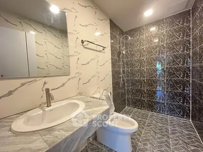 Luxurious modern bathroom with marble tiles and sleek fixtures