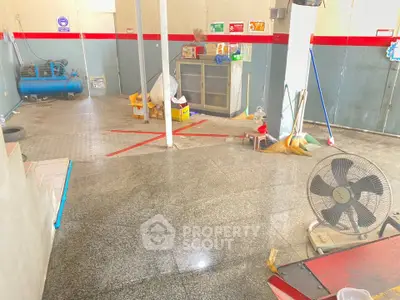 Spacious storage area with polished floors and cleaning equipment