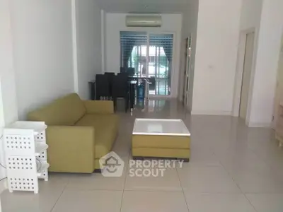 Spacious living room with modern furniture and large windows for natural light.