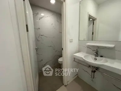 Modern bathroom with sleek marble tiles and contemporary fixtures