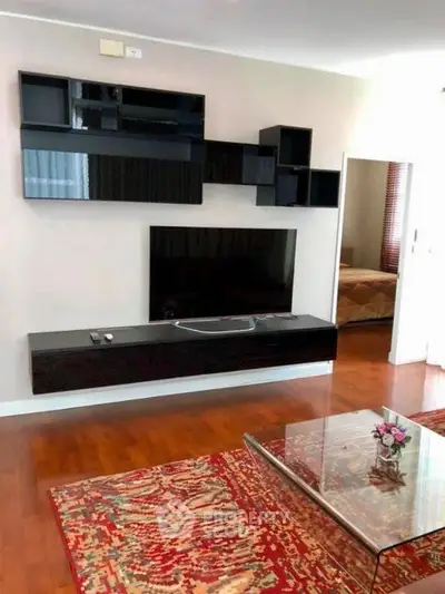 Stylish living room with modern wall-mounted entertainment unit and elegant decor.