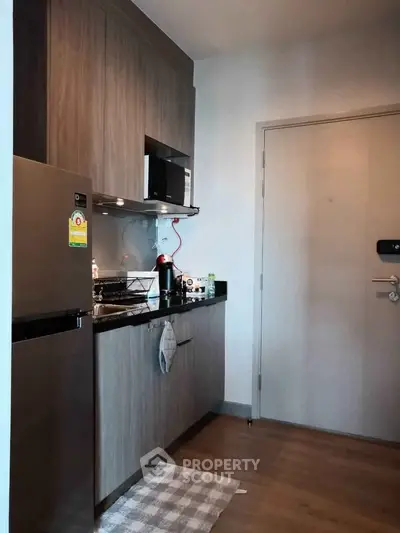 Modern compact kitchen with sleek cabinets and stainless steel appliances