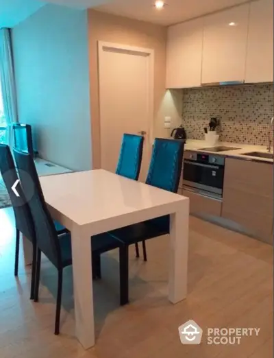 Modern kitchen with sleek dining area and stylish cabinetry