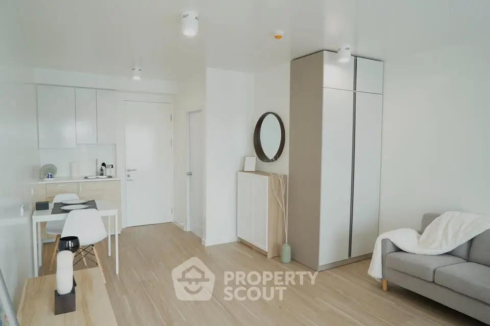 Modern minimalist living room with sleek kitchen and cozy sofa