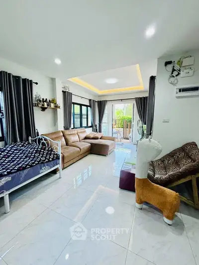 Spacious living room with modern decor and large windows for natural light