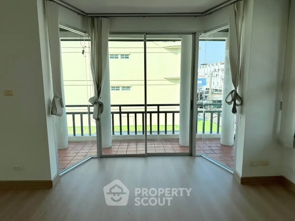 Spacious corner unit with large windows and balcony, offering abundant natural light and a modern open layout.