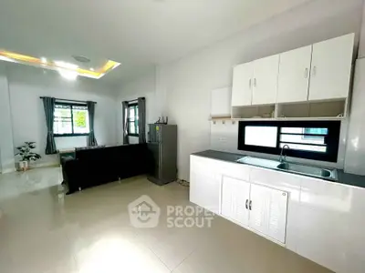 Spacious modern living room with open kitchen and sleek design