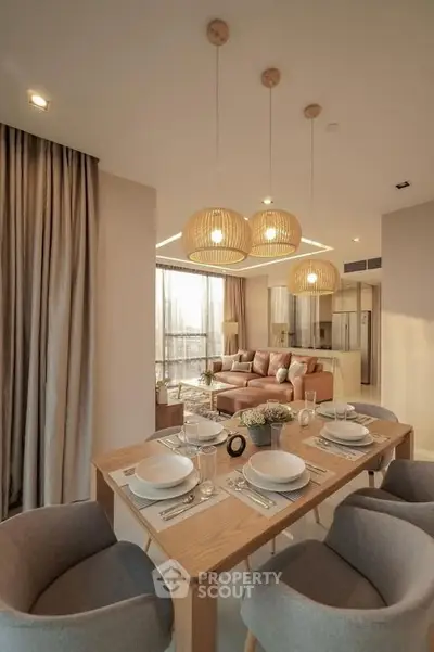 Modern open-plan living room with elegant dining area and stylish lighting