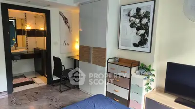 Modern bedroom with stylish decor and ensuite bathroom in a cozy apartment.