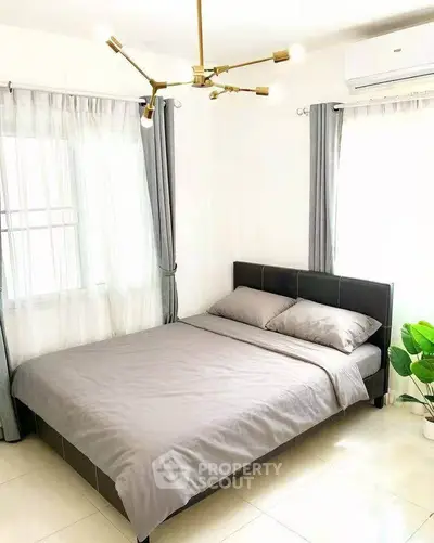 Modern bedroom with stylish lighting and natural light