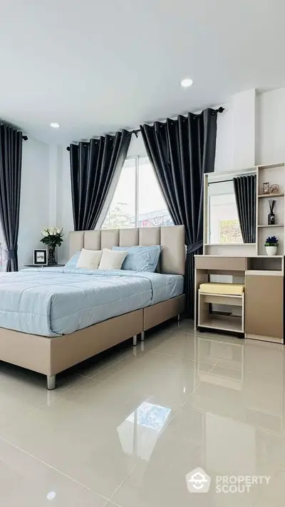 Modern bedroom with sleek design, large windows, and elegant furnishings for a luxurious living experience.