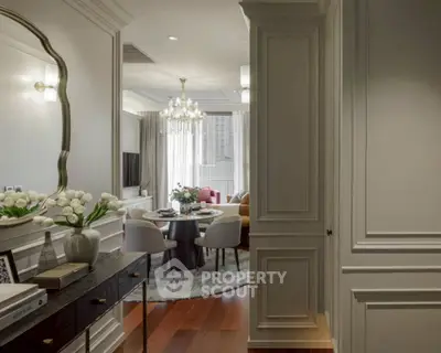 Elegant living room with chandelier, dining area, and stylish decor in modern apartment.
