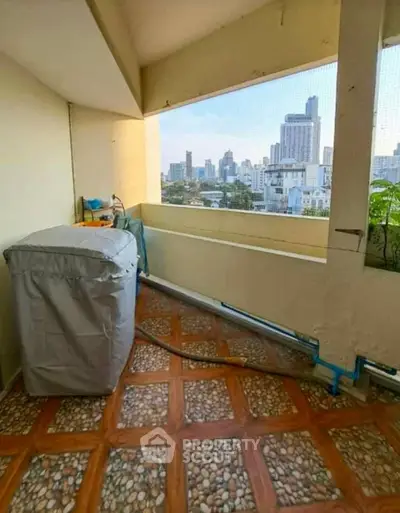 Spacious balcony with city view, perfect for relaxation and enjoying urban skyline.