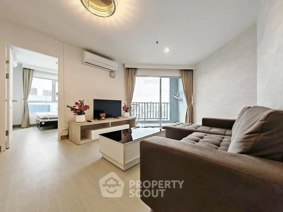 Modern living room with balcony view and stylish furniture in a bright apartment.