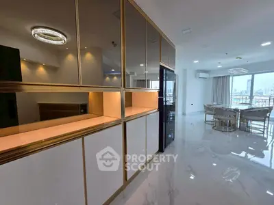 Luxurious modern living room with open layout and city view, featuring elegant dining area and sleek cabinetry.
