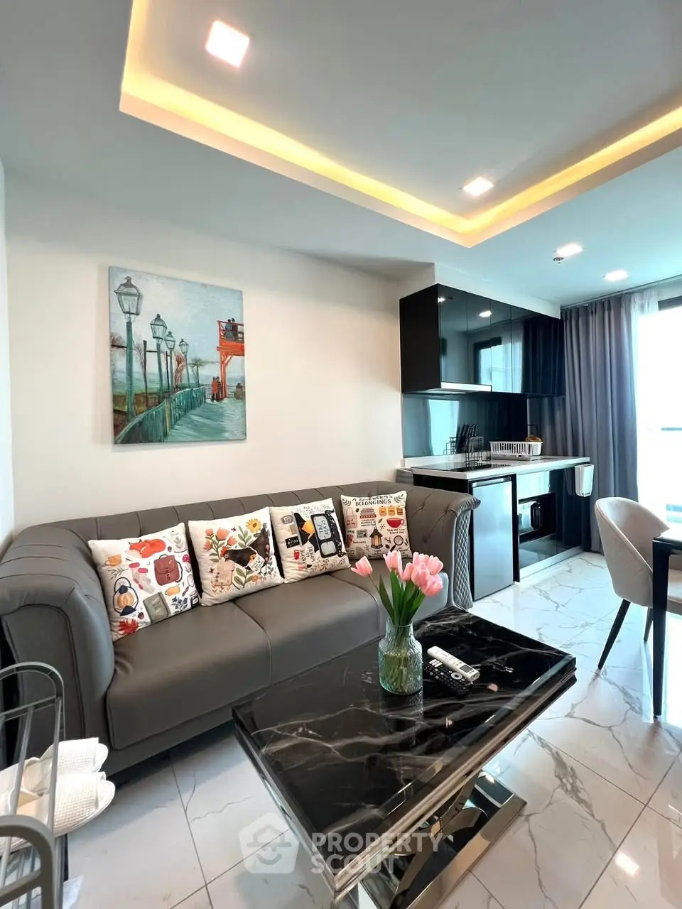 Modern living room with sleek kitchen, marble floors, and stylish decor.