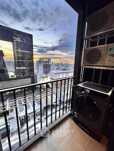 Stunning city view from modern balcony with washing machine and air conditioning units.