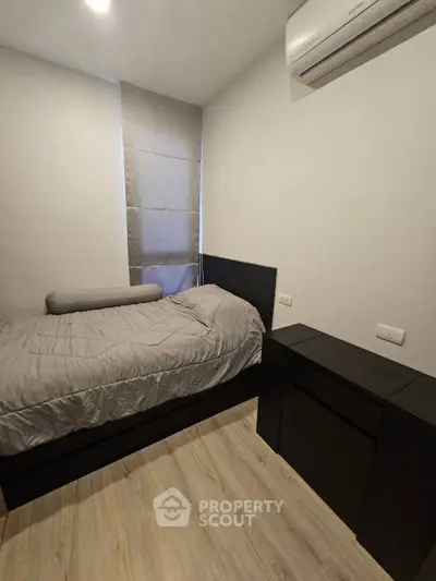 Cozy bedroom with modern furnishings and air conditioning unit