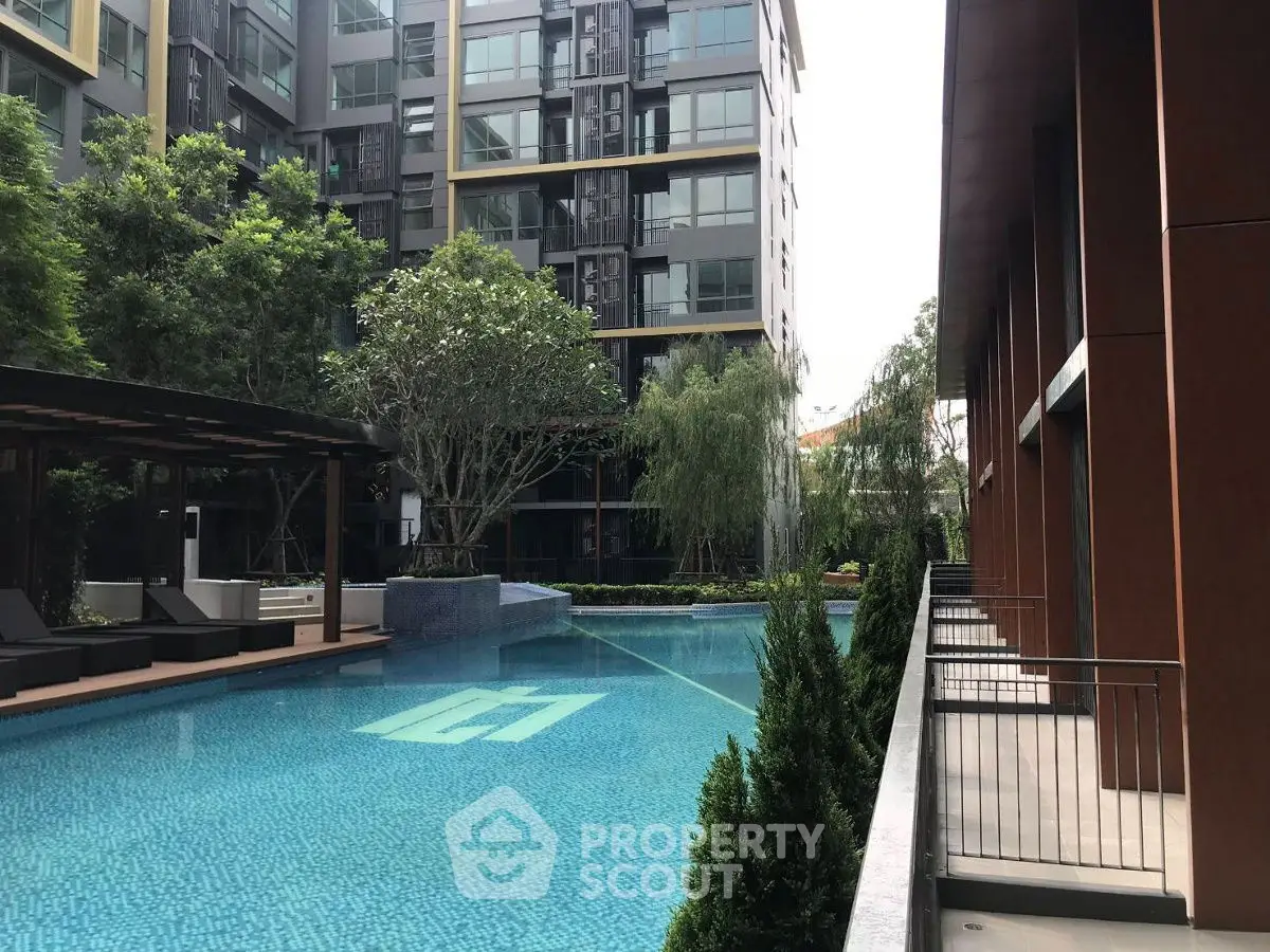 Luxurious condominium with stunning pool and lush greenery, perfect for relaxation and modern living.