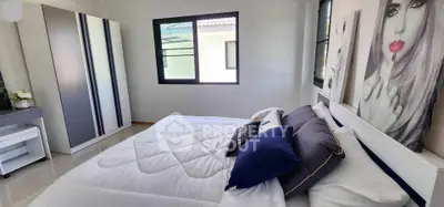 Modern bedroom with stylish decor and ample natural light