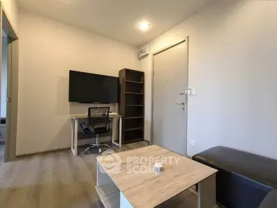 Modern living room with sleek furniture and wall-mounted TV