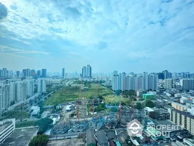 Stunning cityscape view from high-rise building showcasing urban skyline and construction site.