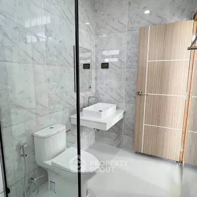 Modern bathroom with sleek marble tiles and minimalist fixtures