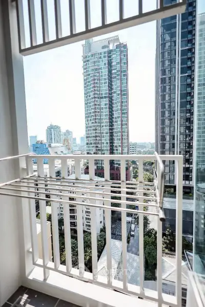 Stunning city view from a modern apartment balcony with sleek railing design.