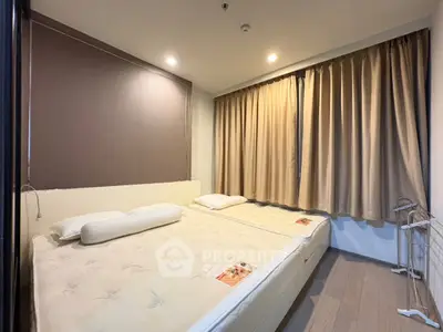 Cozy bedroom with twin beds and warm lighting, perfect for restful nights.