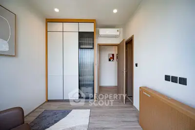 Modern bedroom with sleek wardrobe and air conditioning unit