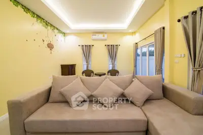Spacious living room with modern beige sofa and elegant decor