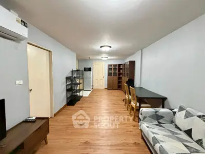 Spacious living room with modern decor and wooden flooring