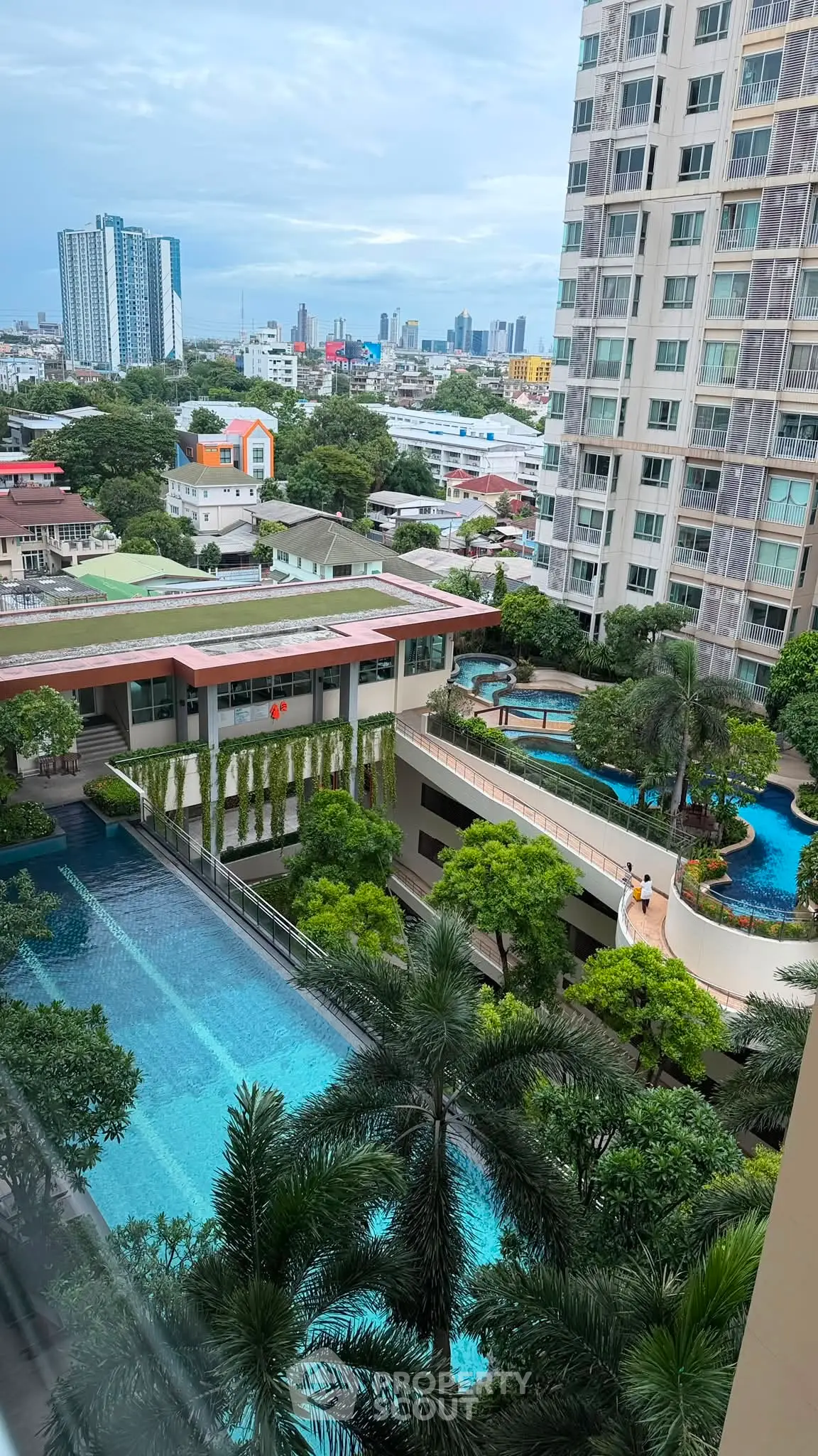 Luxurious condominium with stunning pool and city view, perfect for urban living.