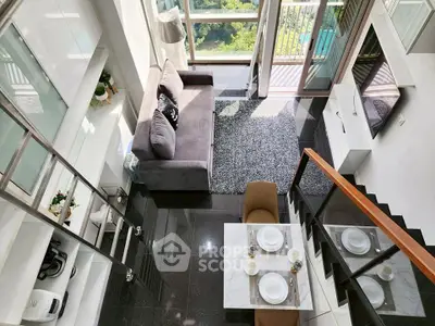 Modern loft apartment with mezzanine, stylish furniture, and large windows offering natural light and scenic views.