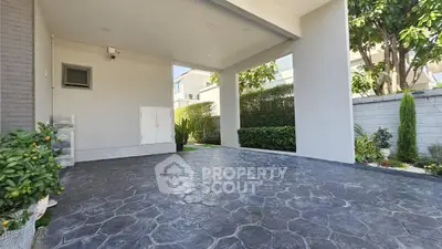 Spacious modern driveway with elegant stone paving and lush greenery